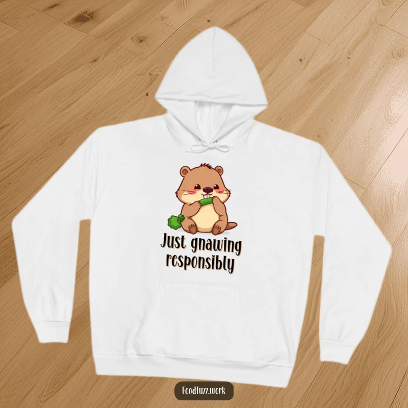 Funny beaver hoodie depicting a focused beaver diligently gnawing on a slender cucumber, ideal for those who love hard work and humor.